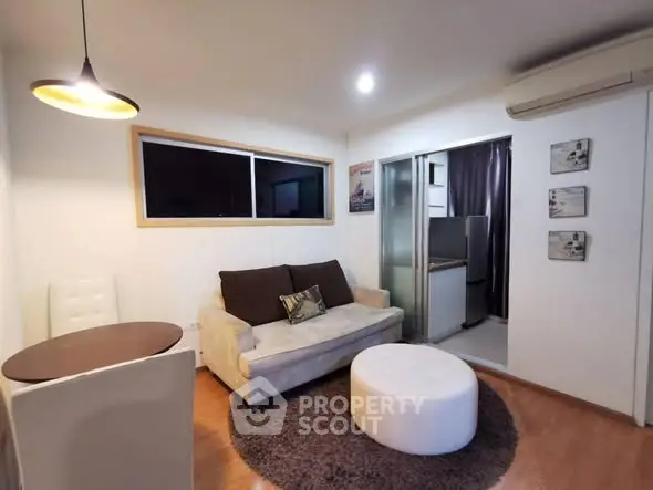 Cozy living room with modern decor and open kitchen layout