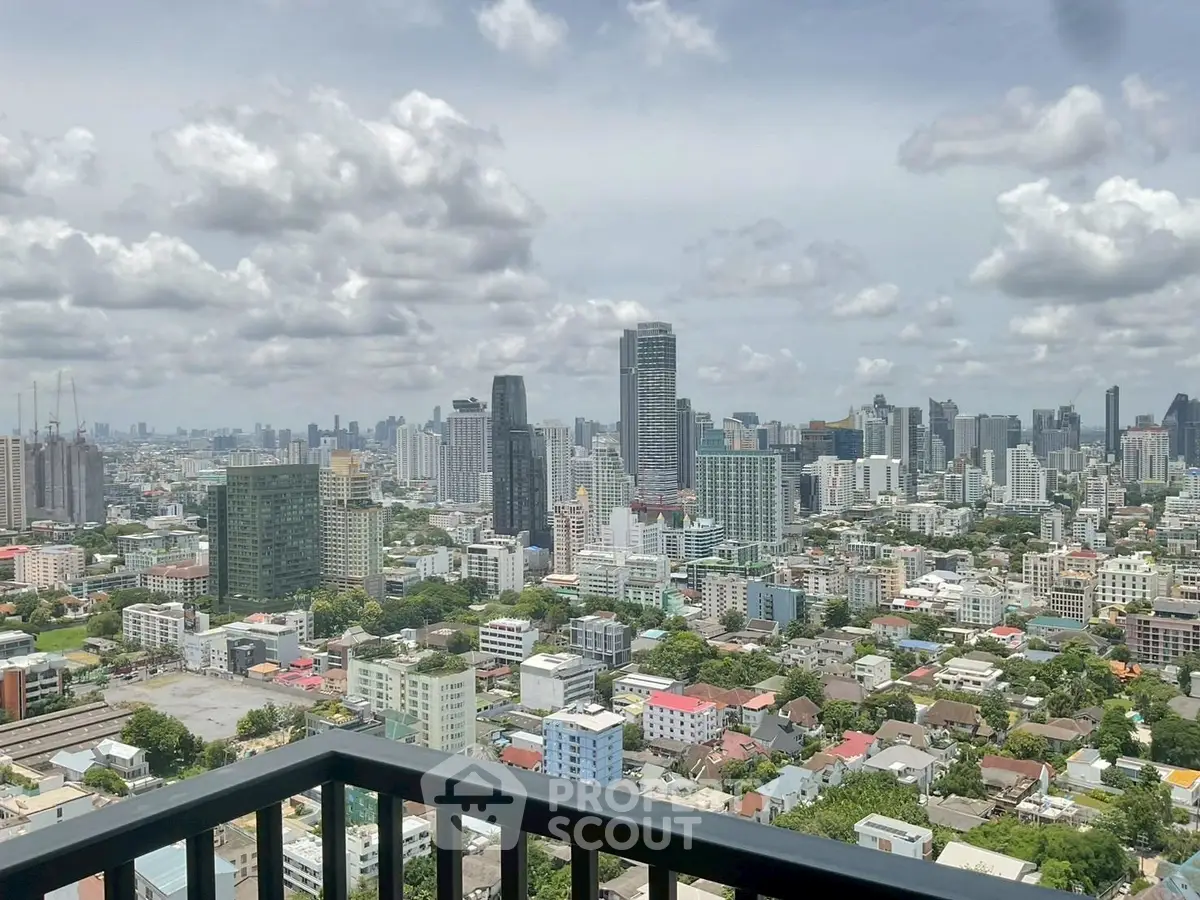 Stunning cityscape view from high-rise balcony overlooking urban skyline.