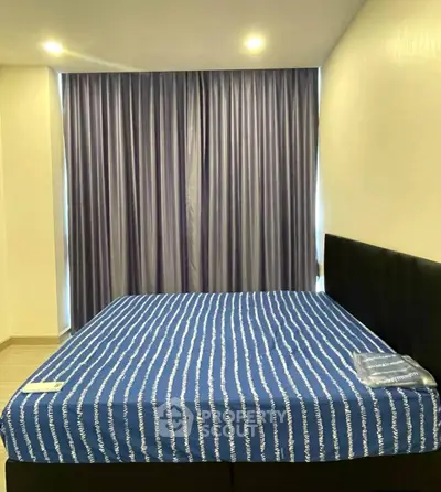 Spacious bedroom with modern design and elegant curtains