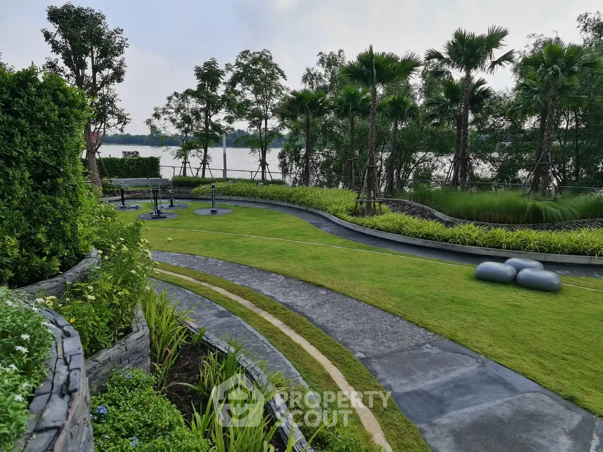 Lush garden with scenic river view and landscaped pathways