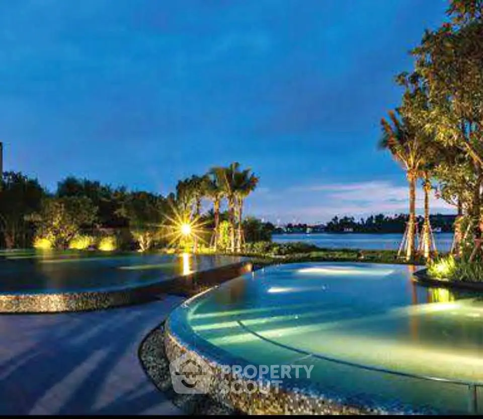 Luxurious outdoor pool area with stunning evening view and lush greenery.