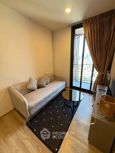 Cozy living room with city view balcony, modern sofa, and stylish decor.