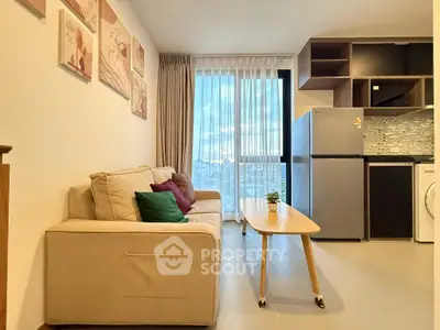 Modern living room with cozy sofa, stylish decor, and open kitchen layout in a high-rise apartment.