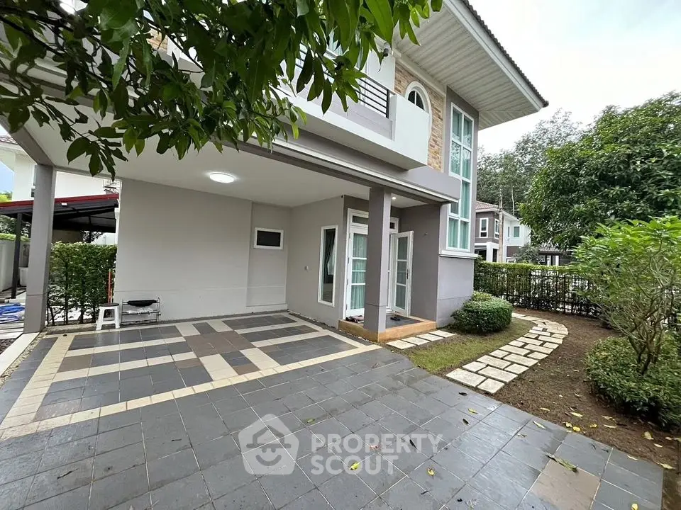 Modern two-story house with spacious driveway and lush garden