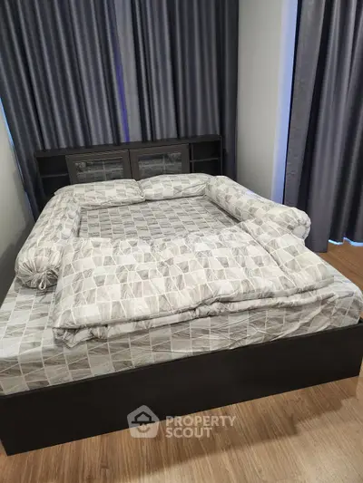 Spacious bedroom with modern bed and elegant curtains, perfect for a cozy retreat.