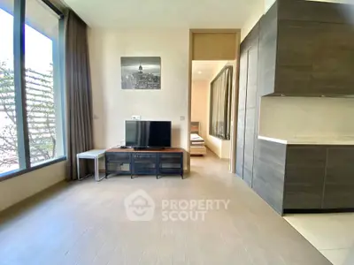 Modern living room with large windows and sleek kitchen design, perfect for urban living.
