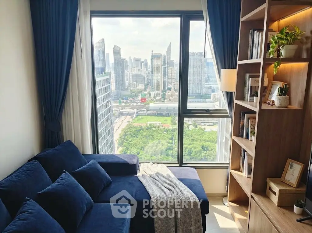 Modern living room with city view and stylish blue sofa