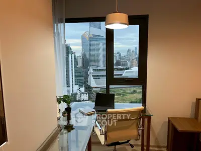 Modern study room with city view, glass desk, and sleek chair in high-rise apartment.