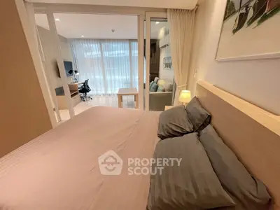 Modern bedroom with cozy decor and study area in a stylish apartment