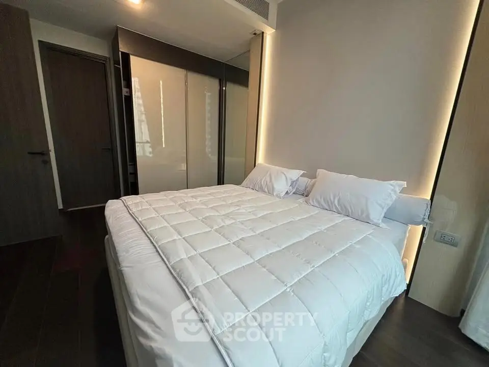 Modern bedroom with sleek design and ambient lighting
