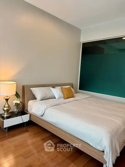 Modern bedroom with stylish decor and cozy ambiance, featuring a comfortable bed and elegant lighting.