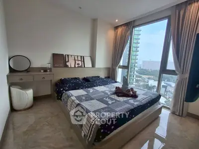 Spacious bedroom with large window offering stunning city view