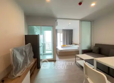 Modern studio apartment with open layout and balcony access