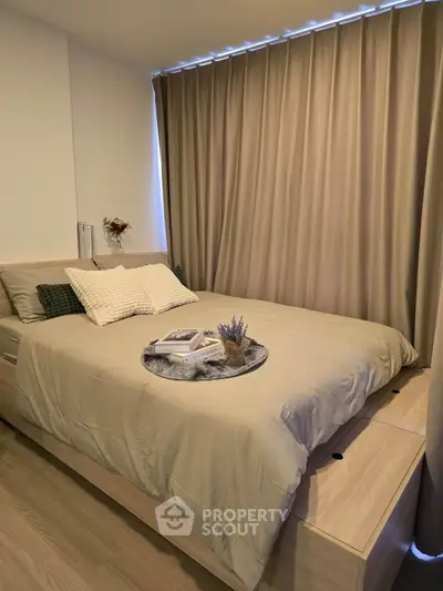 Cozy bedroom with elegant decor and soft lighting, featuring a comfortable bed and stylish curtains.