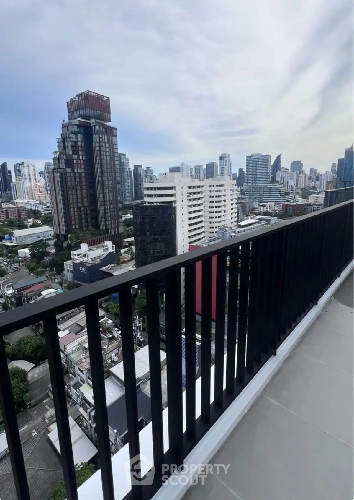 Stunning cityscape view from a high-rise balcony in urban setting.