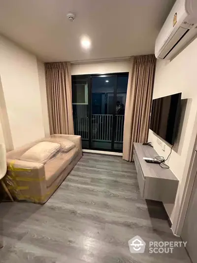 Modern living room with balcony access and sleek flooring