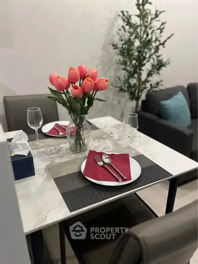 Elegant dining setup with tulip centerpiece in modern living space