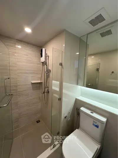 Modern bathroom with glass shower and sleek fixtures