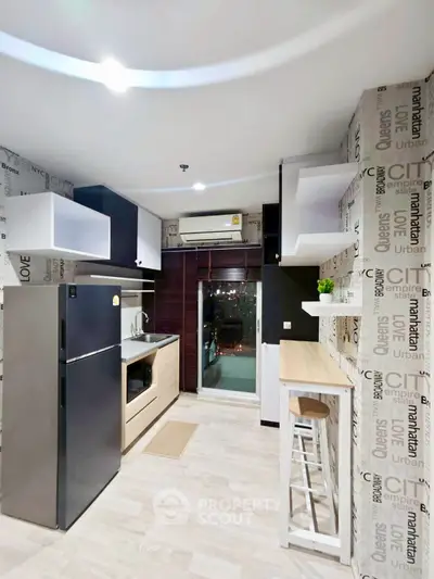 Modern kitchen with sleek appliances and stylish decor in a contemporary apartment.