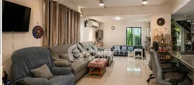 Spacious living room with modern furniture and natural light, perfect for family gatherings.
