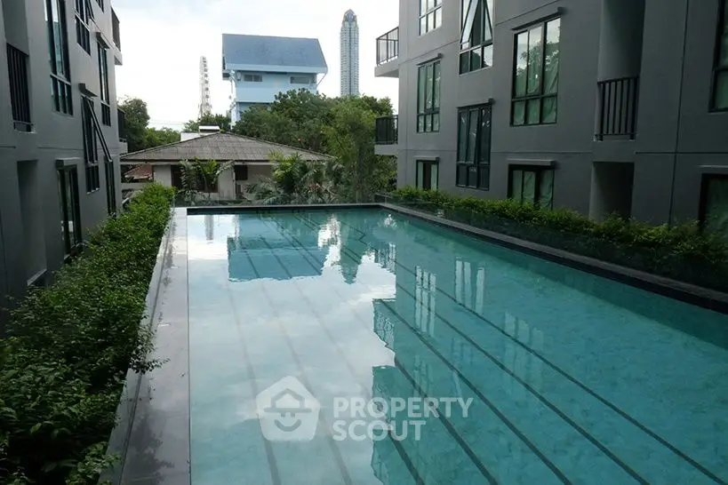 Luxurious condominium with serene pool view and modern architecture