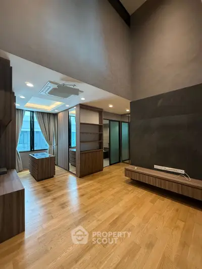 Spacious modern living room with wooden flooring and large windows