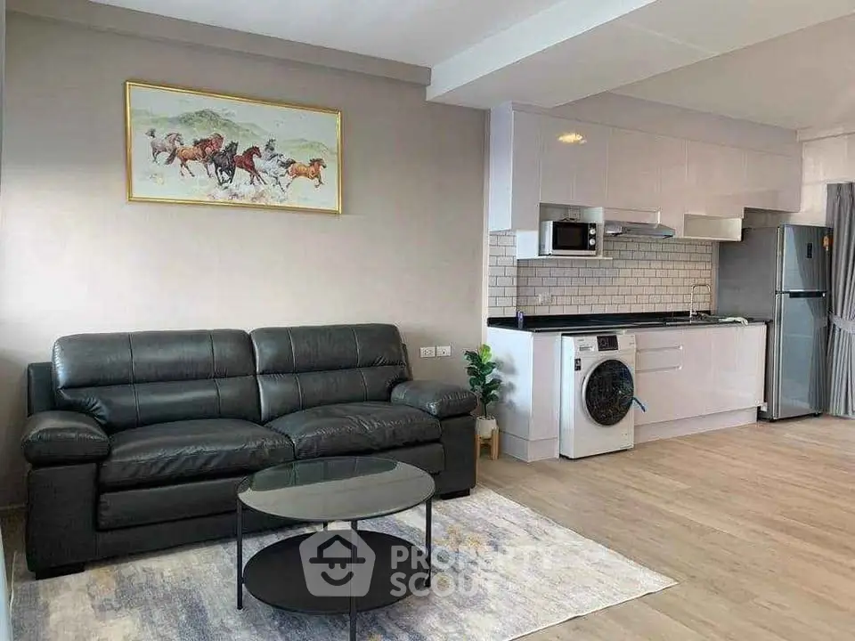 Modern open-plan living room with sleek kitchen and washing machine
