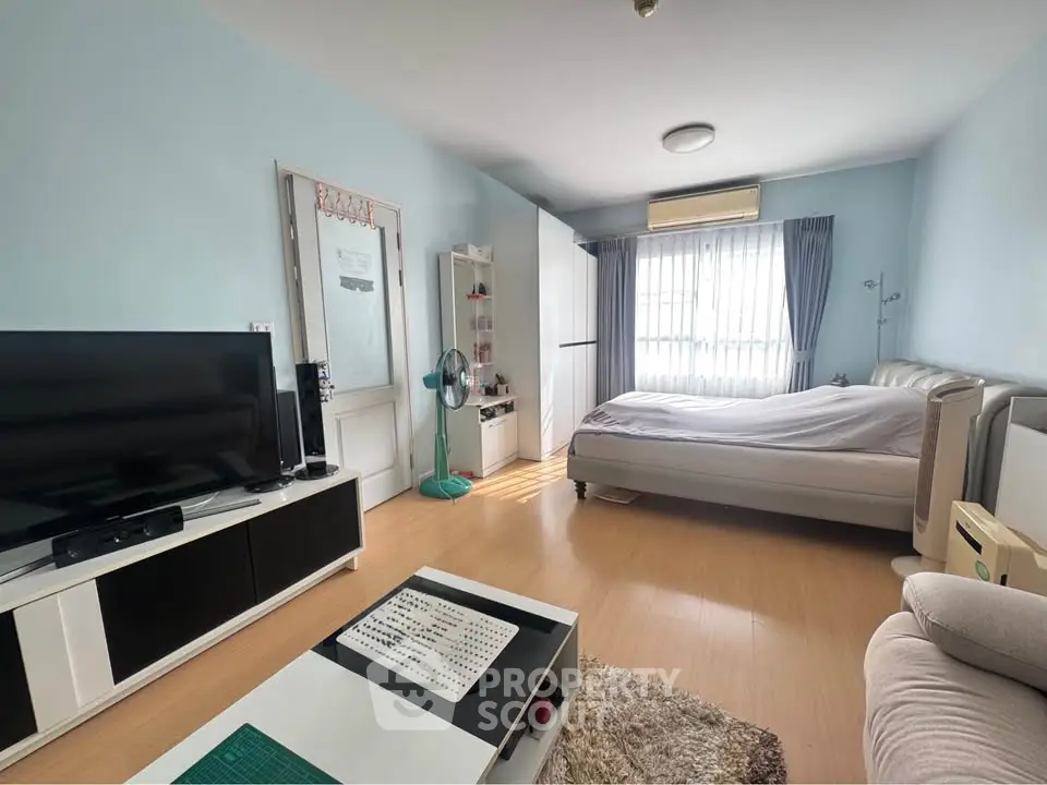 Spacious bedroom with modern decor and natural light