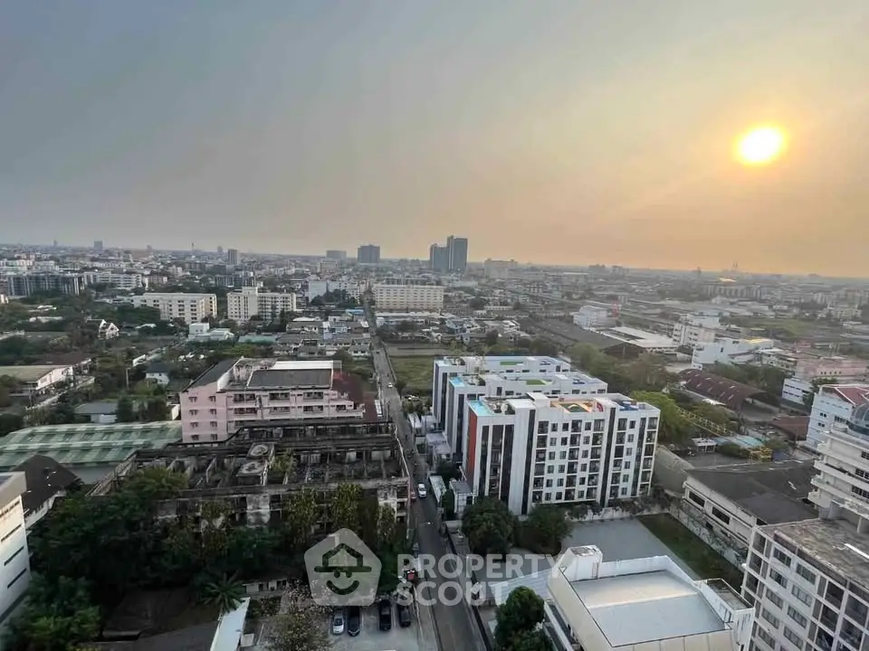Stunning cityscape view from high-rise building at sunset, showcasing urban living.