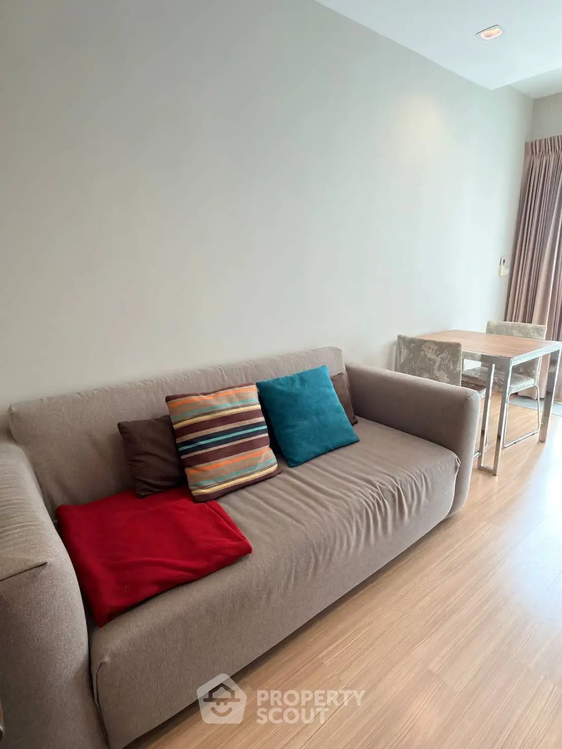 Cozy living room with modern sofa and dining table in stylish apartment