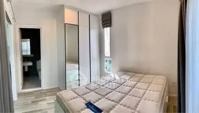 Modern bedroom with large wardrobe and natural light, ideal for comfortable living.