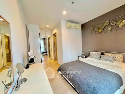 Modern bedroom with stylish decor and ample natural light, featuring a cozy bed and elegant furnishings.