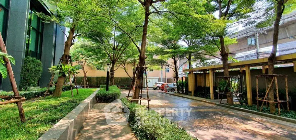 Lush garden area with trees and pathway in modern residential complex