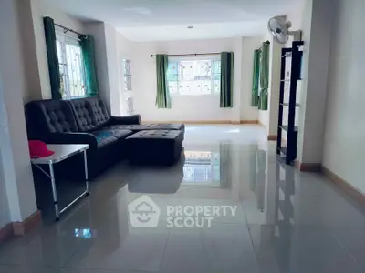 Spacious living room with modern furniture and large windows for natural light.
