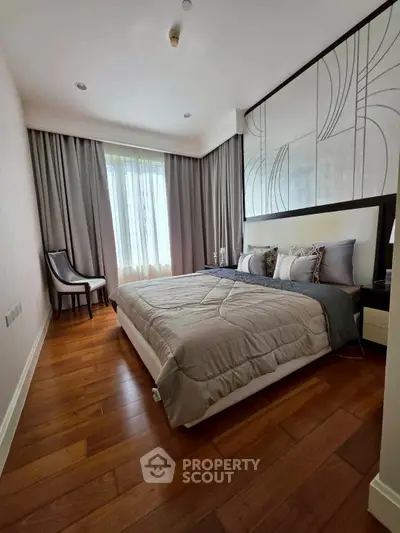 Elegant bedroom with modern decor and large window in luxury apartment
