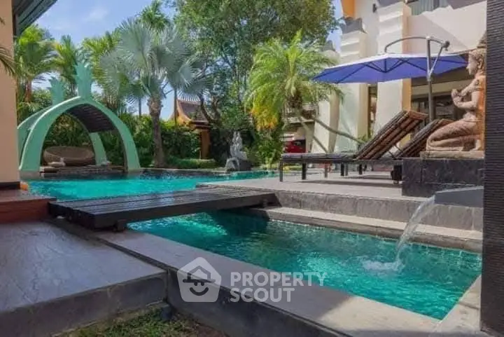 Luxurious poolside oasis with tropical landscaping and modern design.