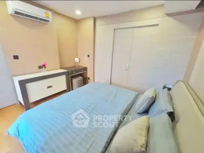 Cozy bedroom with modern decor and air conditioning in a stylish apartment.