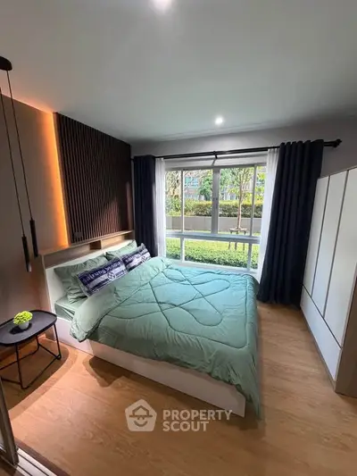 Modern bedroom with large window and stylish decor, featuring a cozy bed and elegant lighting.