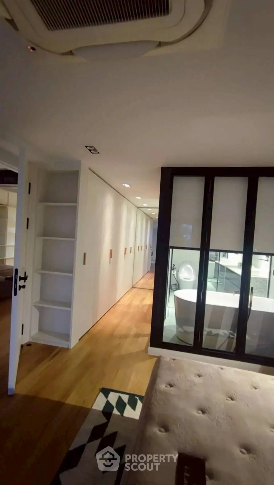 Luxurious bedroom with ensuite bathroom and elegant wooden flooring
