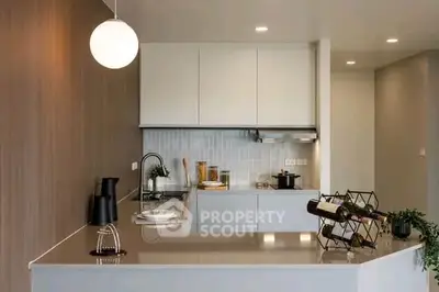 Modern kitchen with sleek design, featuring open layout and stylish fixtures.