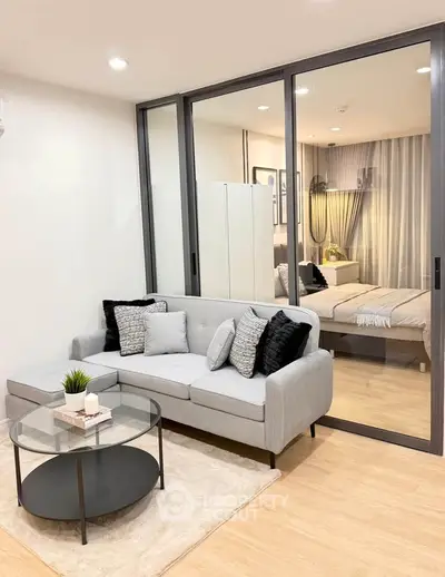 Modern living room with glass partition and cozy bedroom view