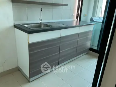 Modern kitchen with sleek cabinetry and stainless steel sink