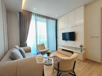 Modern living room with elegant furniture and large window for natural light.