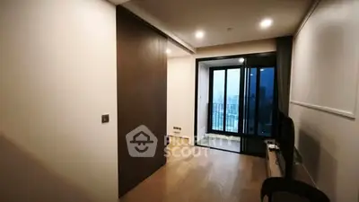 Modern apartment interior with balcony view and sleek wooden flooring.