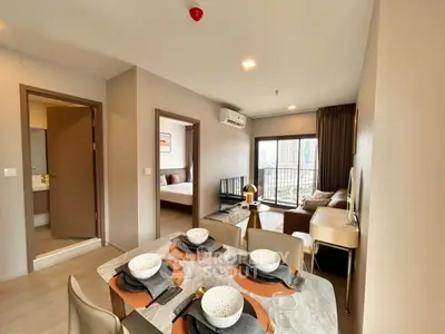 Modern apartment interior with dining area, living room, and city view balcony.