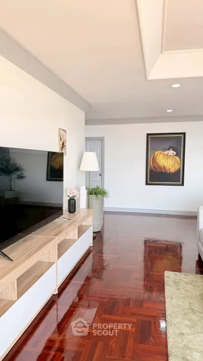 Spacious living room with polished wooden floors and modern decor