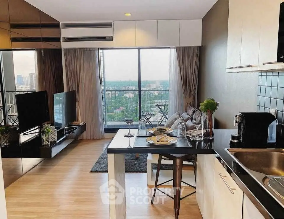 Modern open-plan living room with kitchen and city view balcony