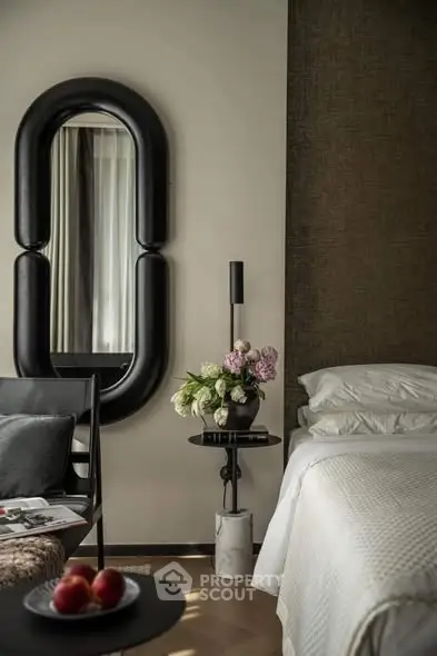 Luxurious bedroom with elegant decor, featuring a stylish mirror and cozy bedding for ultimate comfort.