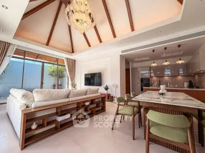 Luxurious open-plan living room with high ceilings and elegant chandelier