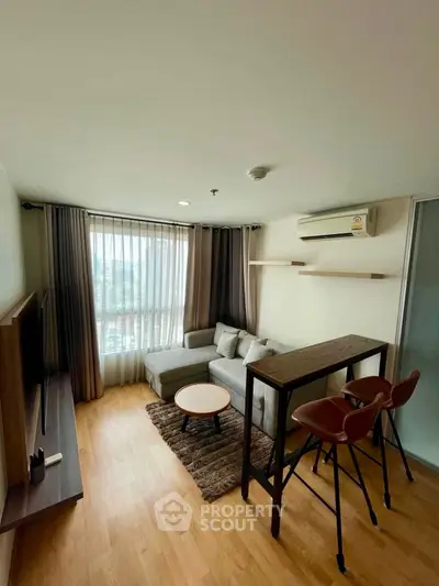 Modern living room with cozy sofa, stylish bar stools, and large window with city view.